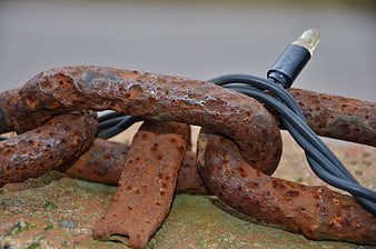 Rusty Anchor Chain with Black Cable Close-Up