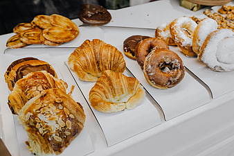 Assorted fresh pastries and donuts in bakery display case