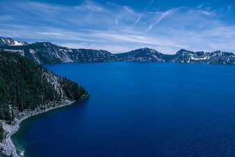 Aerial View of Crater Lake with Deep Blue Water and Forested Rim