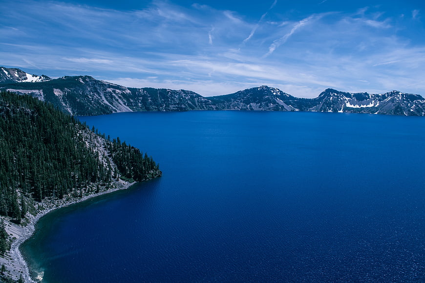 Aerial View of Crater Lake with Deep Blue Water and Forested Rim