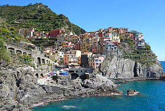 Colorful coastal village on rocky cliffs overlooking the sea