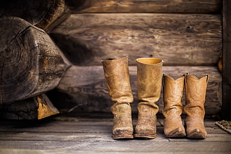 Rustic Cowboy Boots on Wooden Log Cabin Floor