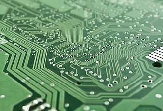Close-up of green circuit board with copper traces