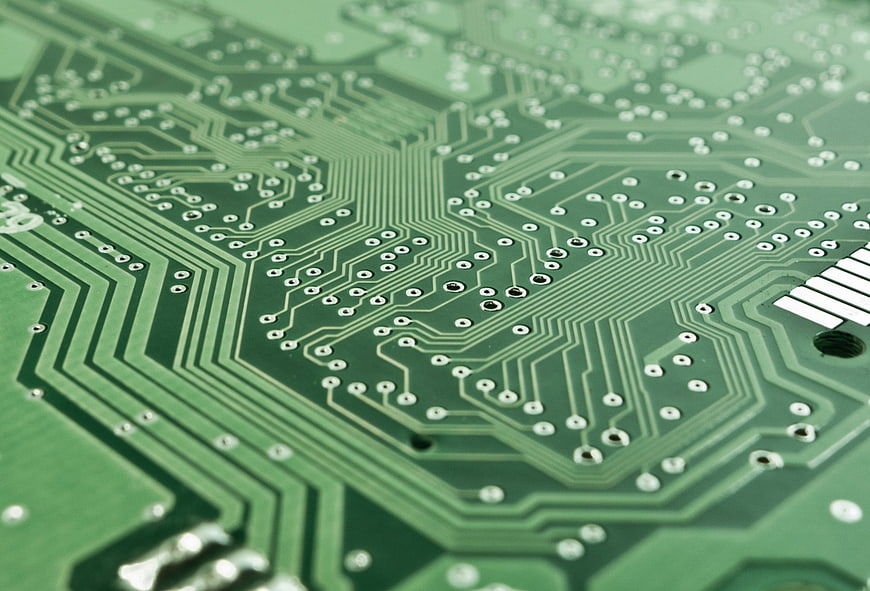 Close-up of green circuit board with copper traces