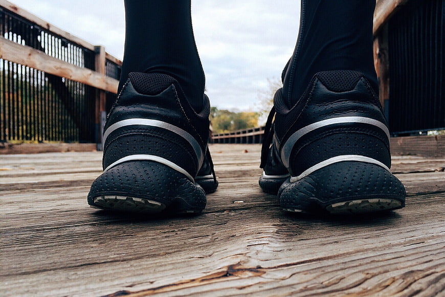 Close-up of black running shoes on wooden deck