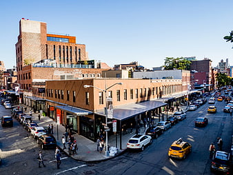 High Angle View of NYC Street Corner with Shops and Traffic