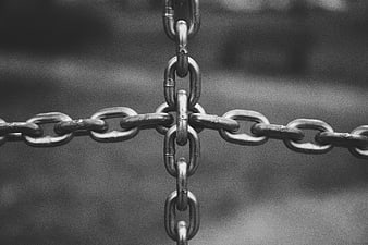 Close-up of interlocking metal chains in black and white
