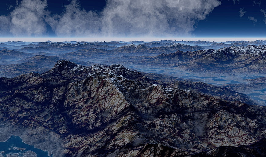 Aerial View of Rugged Mountain Range with Snow-Capped Peaks