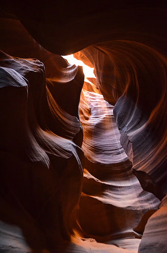 Sunlight streaming through swirling sandstone walls of Antelope Canyon