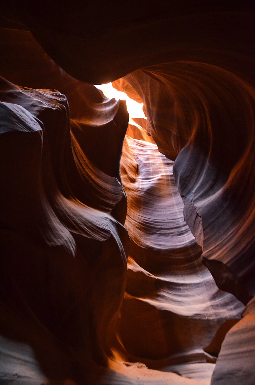 Sunlight streaming through swirling sandstone walls of Antelope Canyon