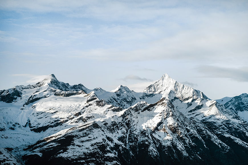 Majestic Snow-Capped Mountain Peaks Under Blue Sky