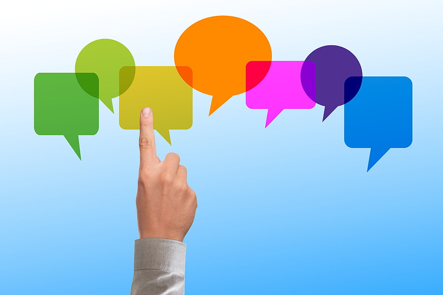 Hand Selecting Colorful Speech Bubbles On Blue Gradient Background