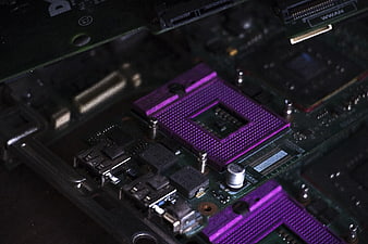 Close-up of purple CPU socket on green motherboard