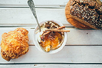 Overhead view of breakfast with croissant, oatmeal, and bread
