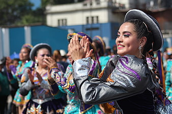 Peruvian Dancer in Traditional Costume Clapping Outdoors
