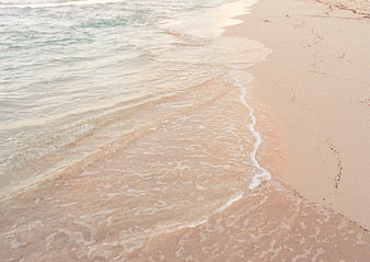 Gentle Ocean Waves Washing Over Sandy Beach Shoreline