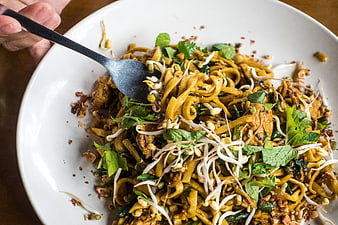 Close-up of Pad Thai noodles with bean sprouts and herbs
