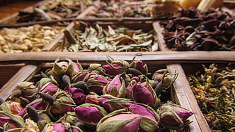 Dried Rose Buds And Spices In Wooden Market Trays