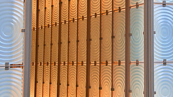Modern architectural facade with textured glass panels and warm lighting