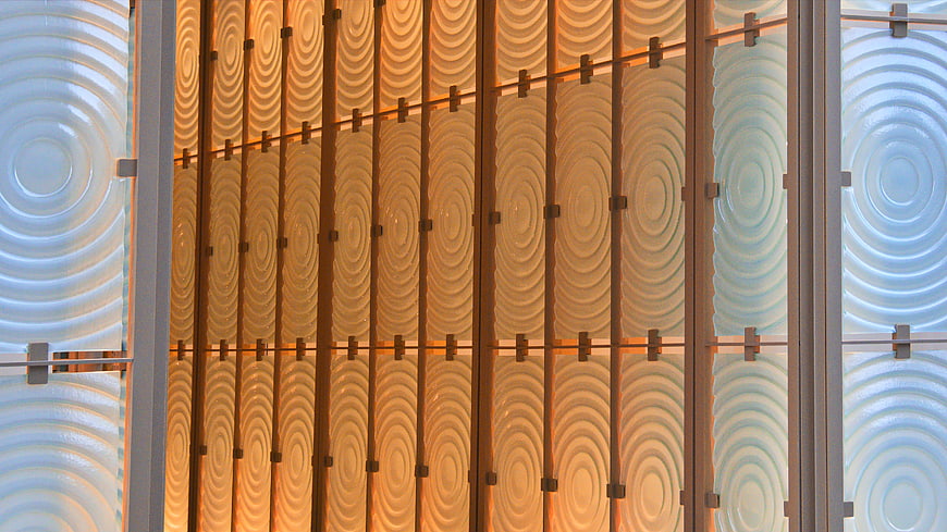 Modern architectural facade with textured glass panels and warm lighting