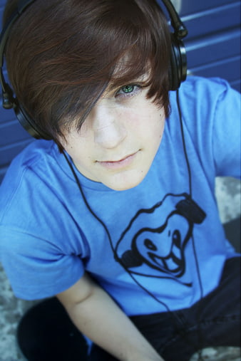 Teenager with headphones looking up at camera