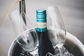 Chilled sparkling wine bottle and glasses in ice bucket