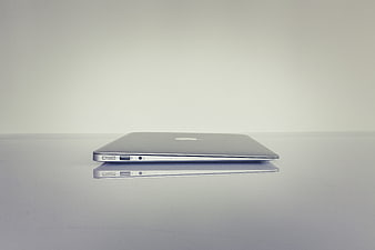 Minimalist Silver Laptop Side Profile On White Surface