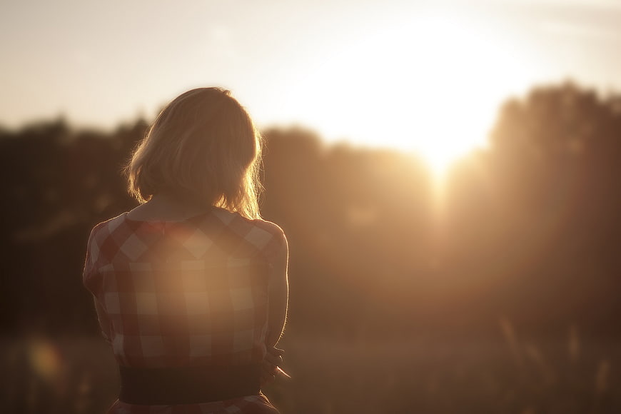 Woman in Checkered Shirt Watching Golden Sunset