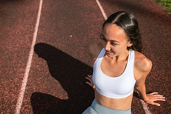 High angle view of fit woman resting on running track