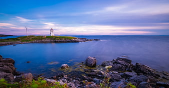 Serene Lighthouse on Rocky Coast at Twilight