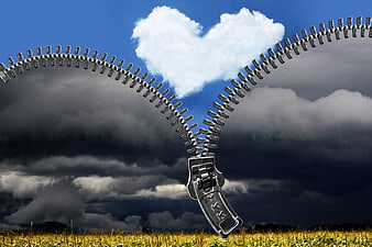 Conceptual zipper opening storm clouds to reveal heart-shaped blue sky