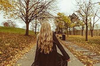 Blonde Woman Walking Away on Autumn Park Path