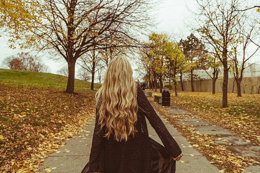 Blonde Woman Walking Away on Autumn Park Path