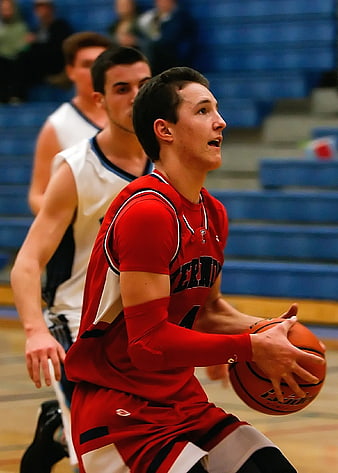Young Basketball Player in Red Jersey Dribbling