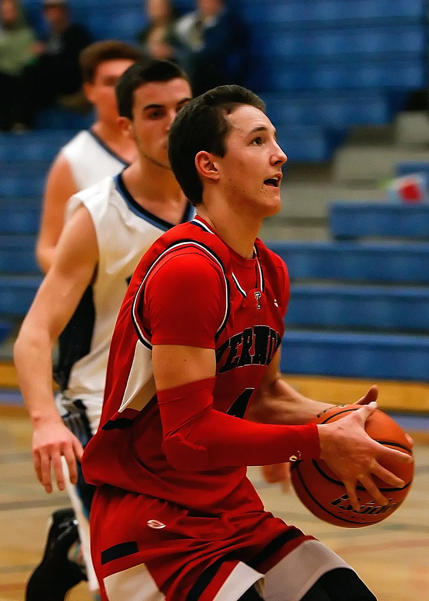 Young Basketball Player in Red Jersey Dribbling