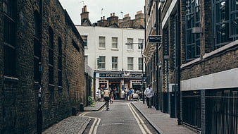 Narrow London street with brick buildings and fish and chips shop