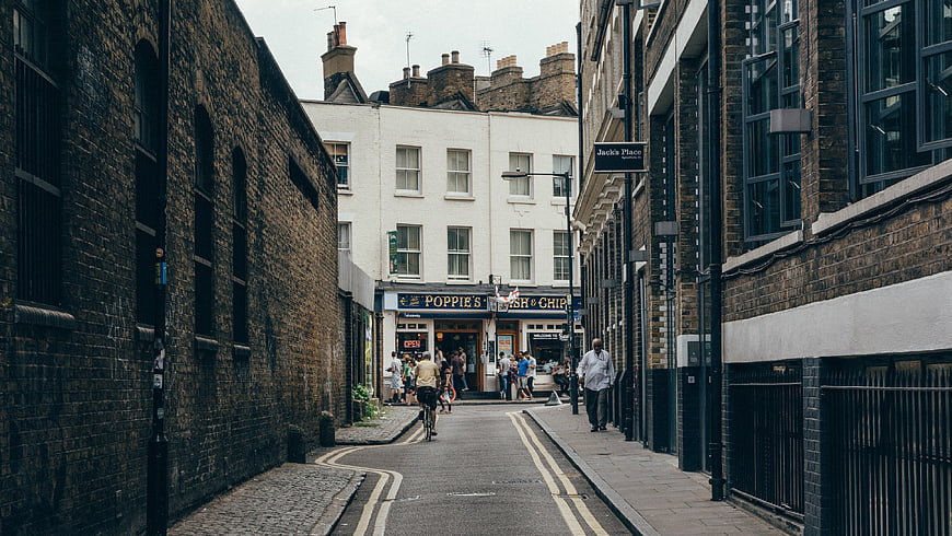 Narrow London street with brick buildings and fish and chips shop