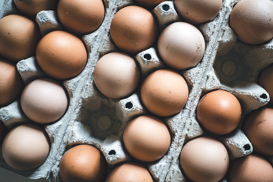 Top View of Brown and White Eggs in Cardboard Carton