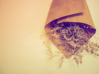 Dried flowers in brown paper on vintage background