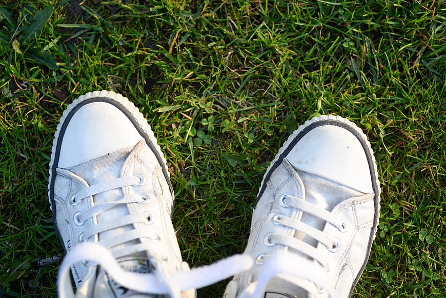 White Canvas Sneakers on Green Grass