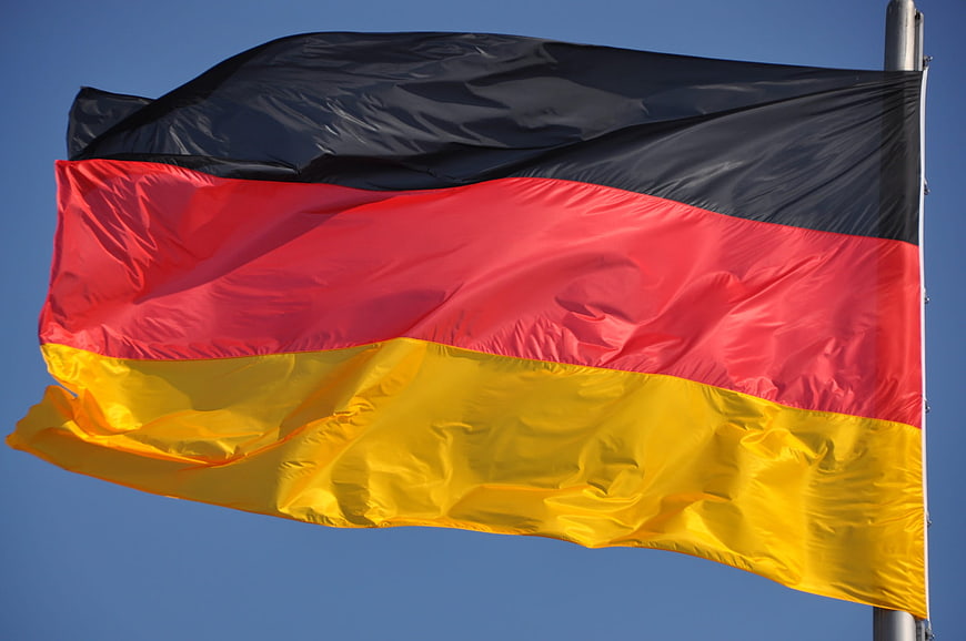 German Flag Waving Against Clear Blue Sky
