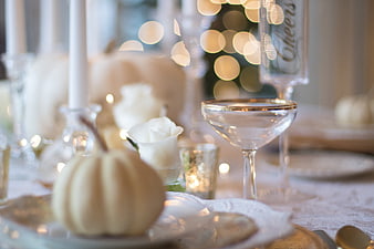 Elegant White and Gold Holiday Table Setting with Pumpkins