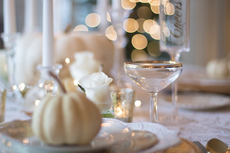 Elegant White and Gold Holiday Table Setting with Pumpkins