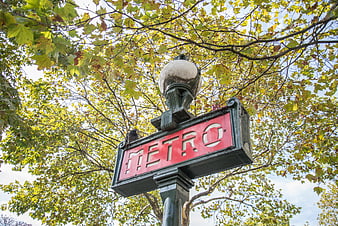 Paris Metro Sign Under Autumn Trees