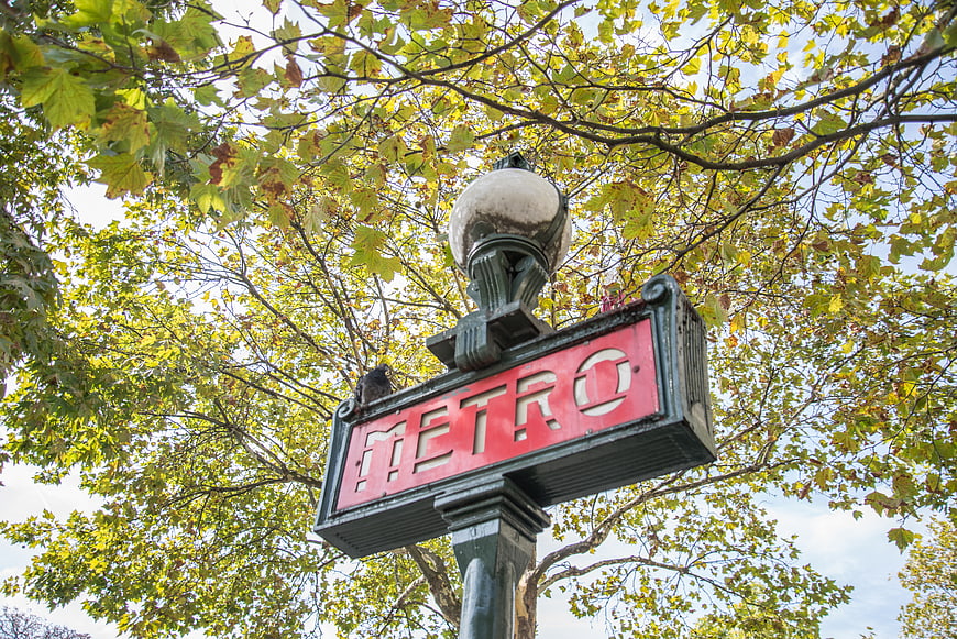 Paris Metro Sign Under Autumn Trees