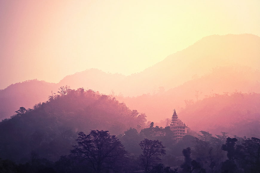 Misty Pink Mountain Landscape with Temple Silhouette at Sunrise