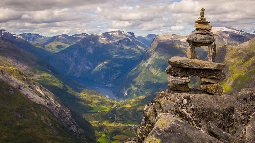 Stone Cairn on Mountain Peak Overlooking Fjord Valley