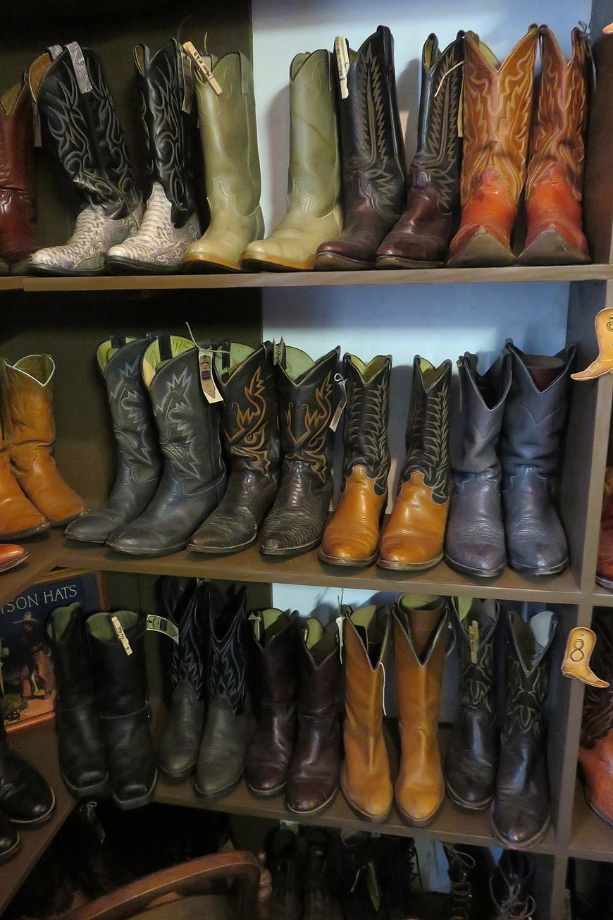 Display of Cowboy Boots on Wooden Shelves