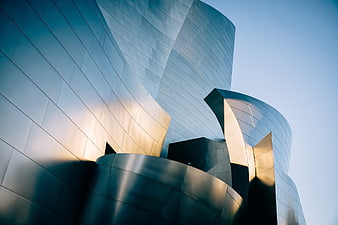 Modern curved metal architecture with golden sunlight