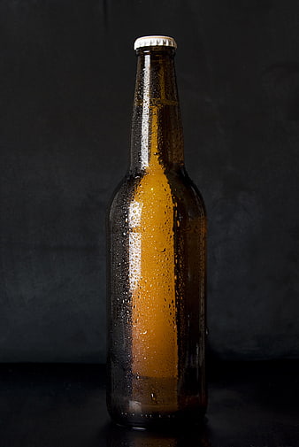 Cold Amber Beer Bottle with Condensation on Dark Background